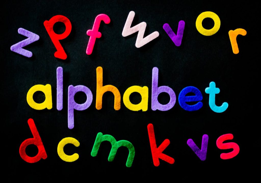 assorted-color-alphabet-on-black-background-1337374 Vibrant colored alphabet letters arranged creatively on a black background for educational purposes.